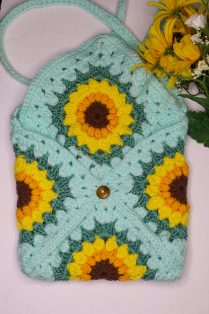 Crocheted bag with sunflower patterns on a light pink background
