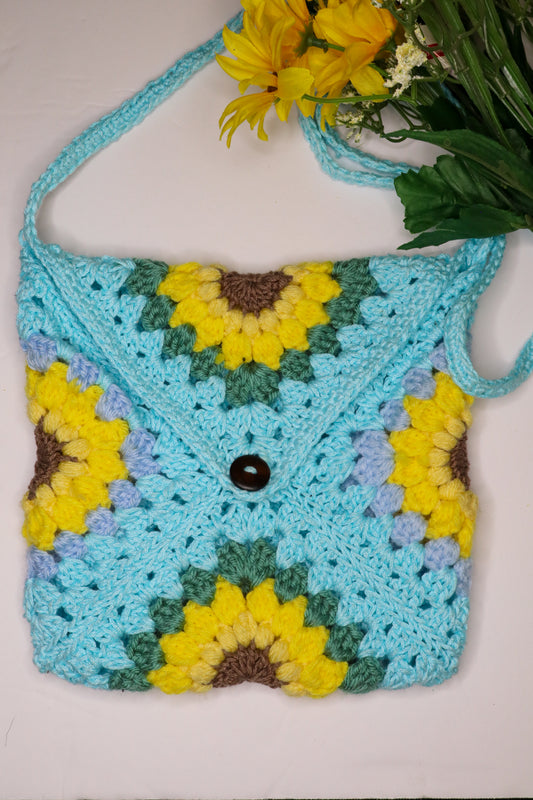 Crocheted bag with sunflower pattern on a white background