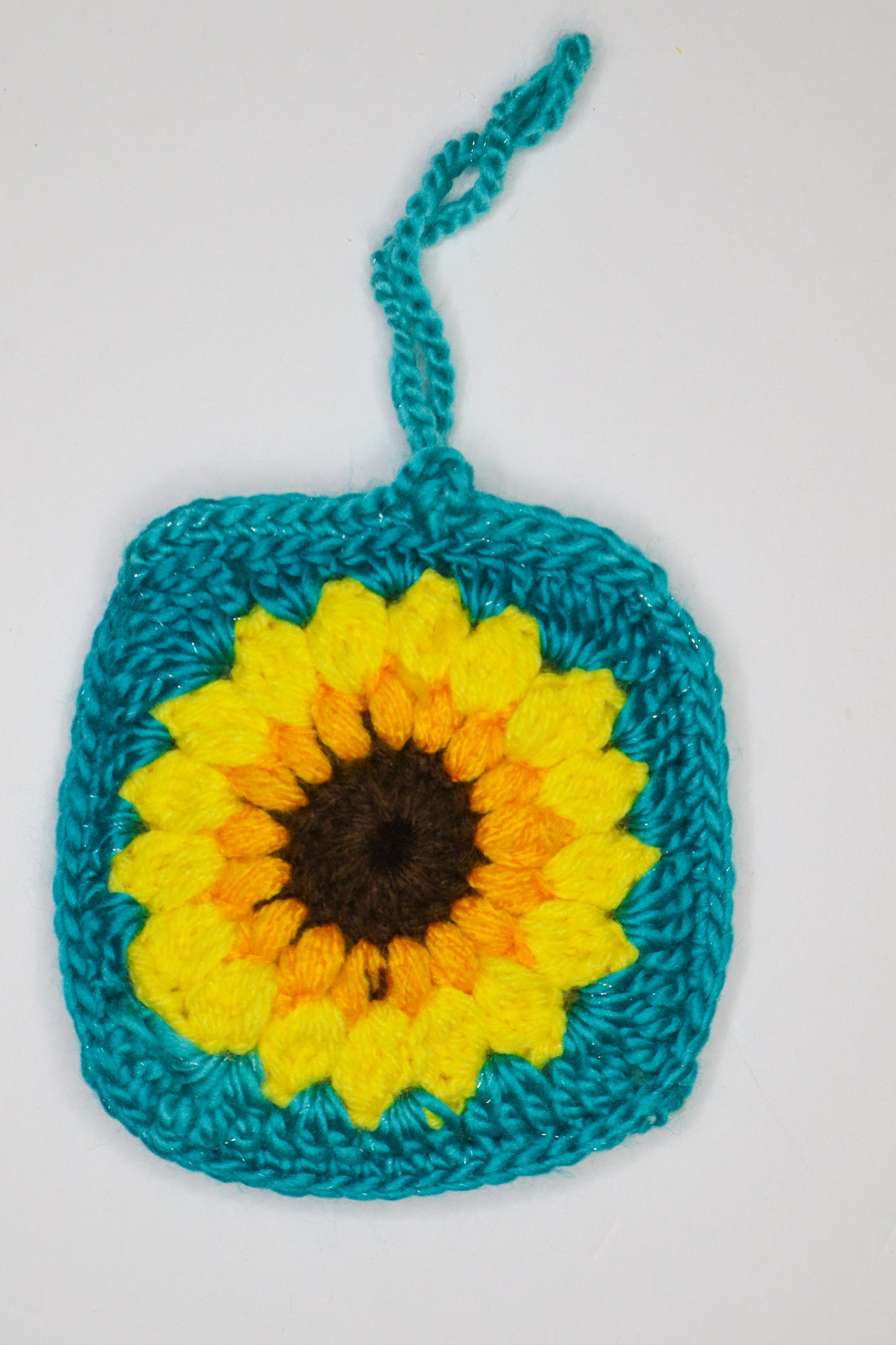 Crocheted square with a sunflower design on a white background