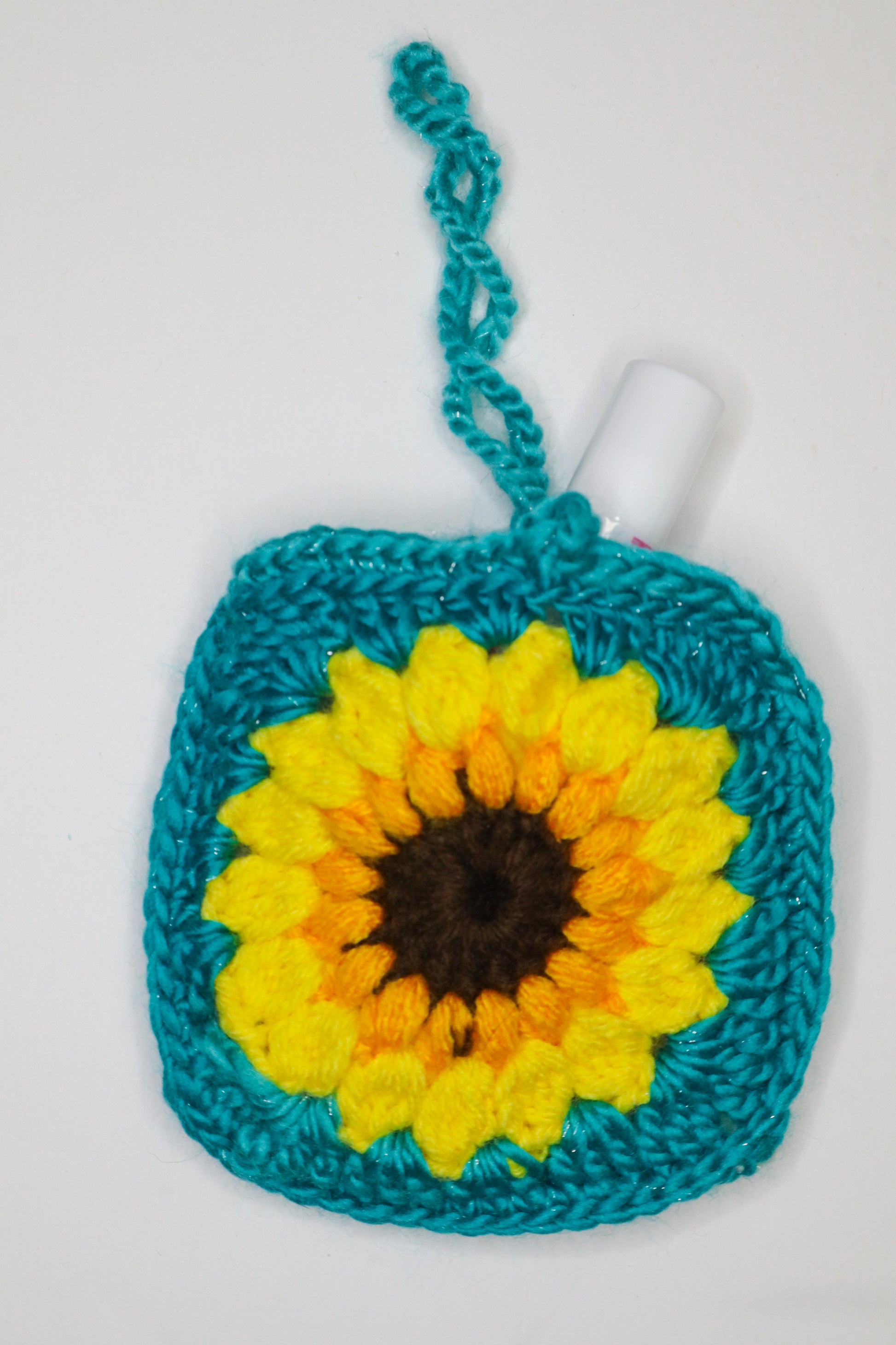 Crocheted square with a sunflower design on a white background