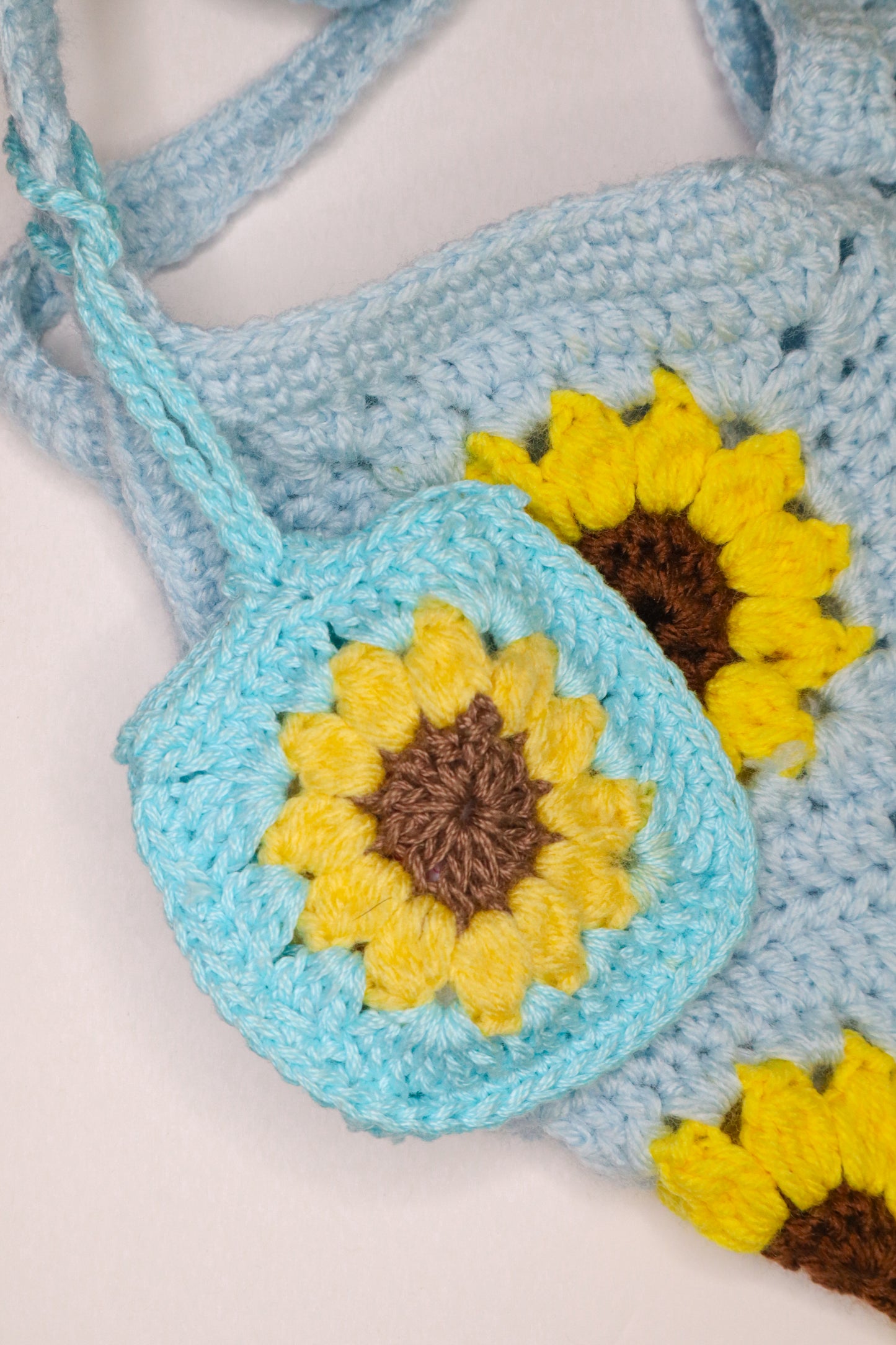 Crocheted bag with sunflower designs on a light background