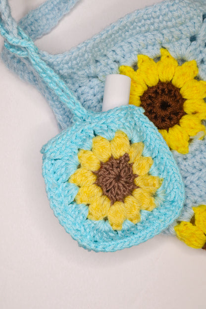 Crocheted bag with sunflower designs on a light background