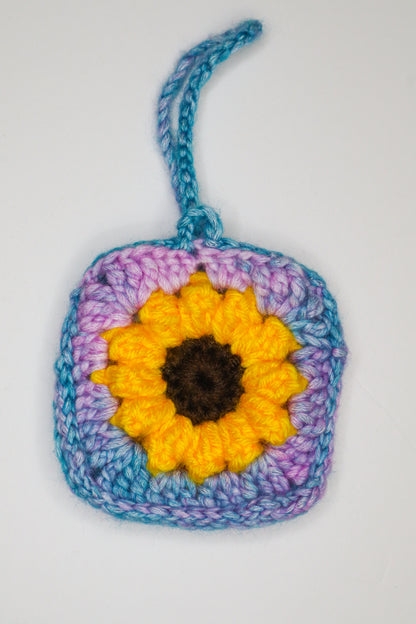 Crocheted square with a sunflower design on a white background